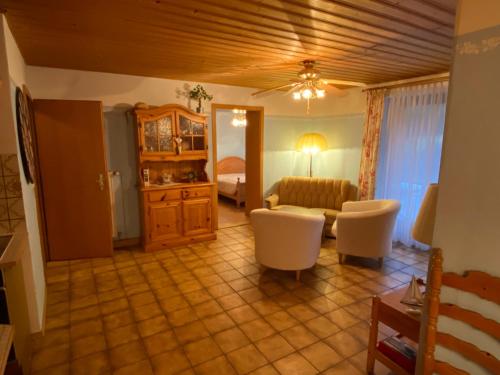 a living room with a couch and a table at Gartenwohnung im Gut Sonnenwald in Schöllnach