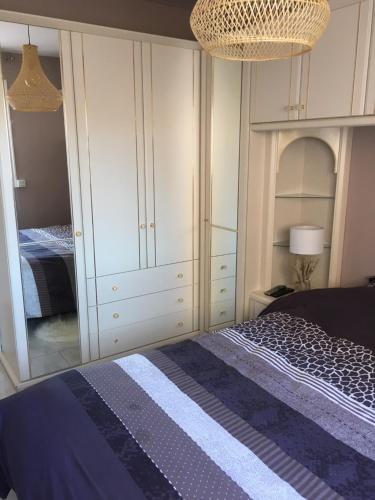 a bedroom with a bed and a large closet at MAZET DE LA MER 54M2 LAVANDOU 100M PLAGE avec PISCINE in Le Lavandou