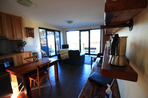 a kitchen and living room with a table and a couch at Down to Earth Farm Retreat in Sarsfield