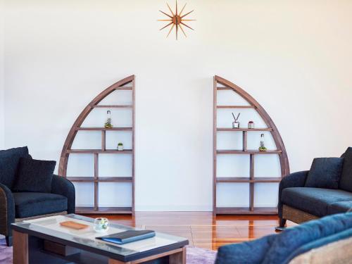 a living room with two chairs and a table at Resort villa miko in Oshima
