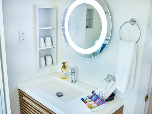 a bathroom with a sink and a mirror at Resort villa miko in Oshima