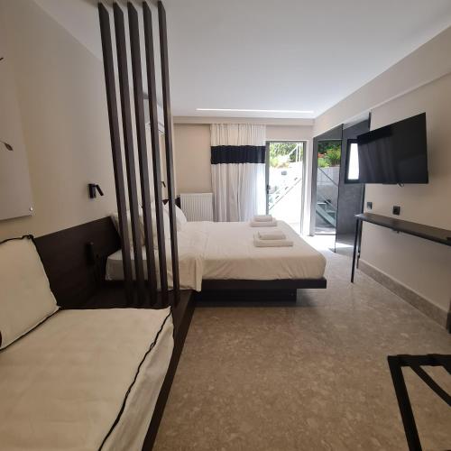 a hotel room with two beds and a couch at Cityzoe Athens Suites in Athens