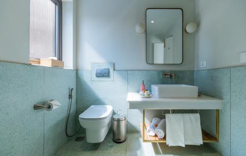 a bathroom with a toilet and a sink and a mirror at Amrit Bhawan in Haridwār