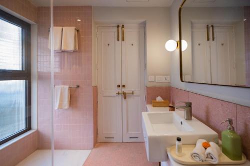 a bathroom with a sink and a mirror at Amrit Bhawan in Haridwār