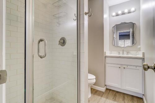a white bathroom with a shower and a toilet at Stones Throw in Hilton Head Island