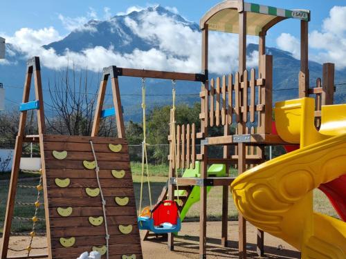 a playground with a slide and a swing at Dream Town Hotel&Restaurant in Kemer