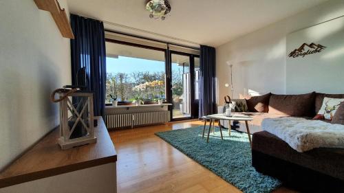 a living room with a couch and a table at Black Forest Bergliebe Pool Terrasse Natur Ruhe Komfort in Höchenschwand