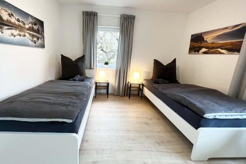 a bedroom with two beds and a window at Cozy House in Zirndorf near Nürnberg in Zirndorf