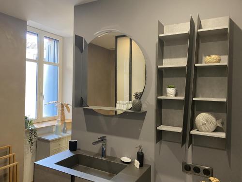 a bathroom with a sink and a mirror at L'équinoxe in Collioure