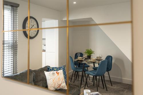 a dining room with a table and chairs and a mirror at High End City Centre Flat - Free Parking - Long Stay Offer in Strood