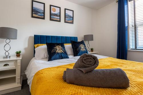 a bedroom with a bed with a towel on it at 5 MINS To CENTRAL - LONG STAY OFFER - FREE PARKING in Strood