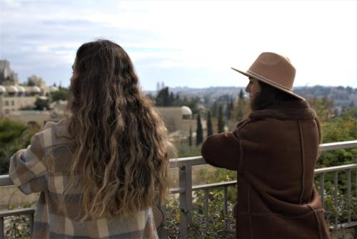 two women looking at the view from a fence at The Post Hostel Jerusalem in Jerusalem