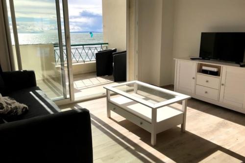 - un salon avec une table basse et une vue sur l'océan dans l'établissement La Croix du Sud superbe appartement en duplex 2 chambres vue mer, au Grau-du-Roi