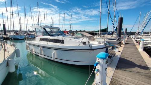 a white boat docked at a dock in the water at La Rochelle sur L'eau in La Rochelle