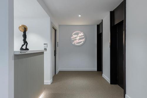 a hallway with a statue of a man on a counter at The Athenians Art Apartments in Athens