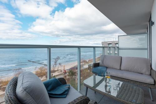 a living room with a view of the ocean at Apartamenty Jantaris SeaView by Renters in Mielno