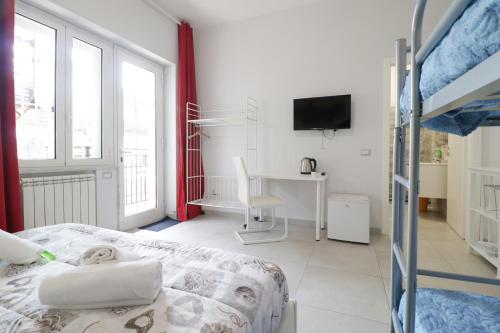 a bedroom with a bed and a desk with a television at Virtus Prestige - Rooms & Apartments in Rome