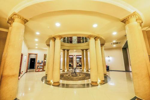 a large lobby with columns in a building at Hotel Astoria Tbilisi in Tbilisi City