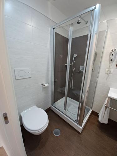 a bathroom with a toilet and a glass shower at Hotel Mimosa Pantheon in Rome