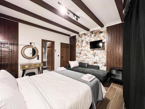 a hotel room with a bed and a couch at The Stone Forest in Kalabaka