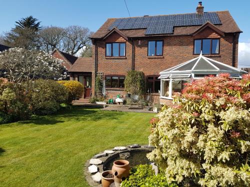 a brick house with a yard with a flower garden at Barn Court Bed and Breakfast in Everton