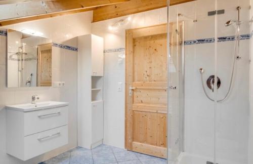 a bathroom with a shower and a sink and a shower backdoor at Ferienwohnung Bergblick für 10 Personen in Unterammergau