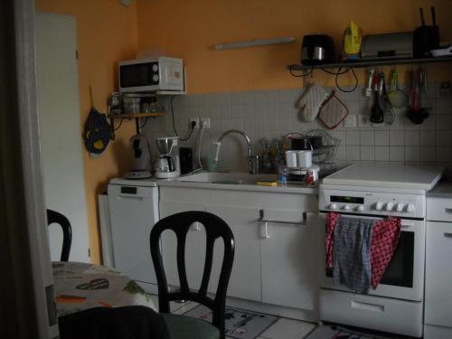 a small kitchen with a sink and a stove at grand appartement en résidence in Vendôme
