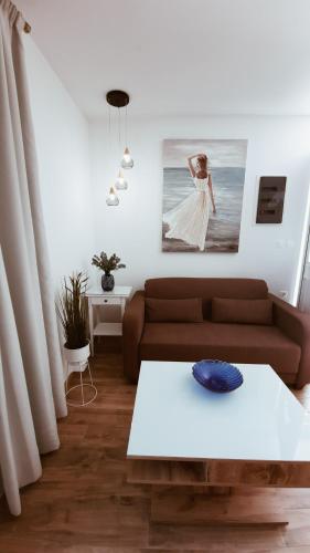 a living room with a couch and a table at Haraki Beach in Haraki