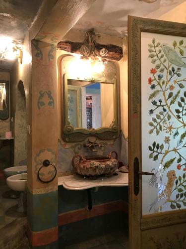 a bathroom with a sink and a mirror at Villa Barberi in Strettoia