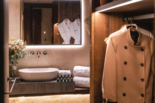 a bathroom with a sink and a mirror and towels at La Ferme Saint Simeon Spa - Relais & Chateaux in Honfleur