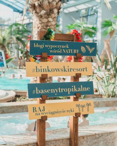 a sign in front of a pool at a resort at Hotel Binkowski in Kielce