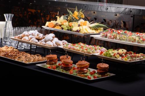 a buffet with many different types of food on trays at Hotel Binkowski in Kielce