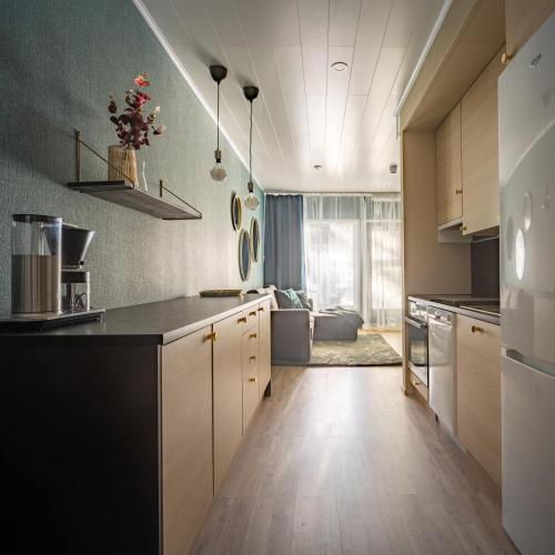 a kitchen with a counter top and a large window at Hilmantori Apartments by Hiekka Booking in Kalajoki