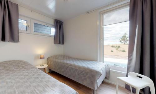 a bedroom with a bed and a large window at Hilmantori Apartments by Hiekka Booking in Kalajoki