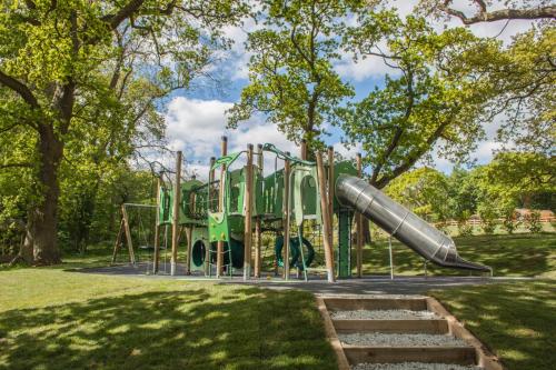 a playground in a park with a slide at High Oaks Grange - Contemporary Lodges in Pickering