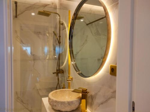 a bathroom with a sink and a mirror at PÓVOA BEACH OCEAN VIEW in Póvoa de Varzim