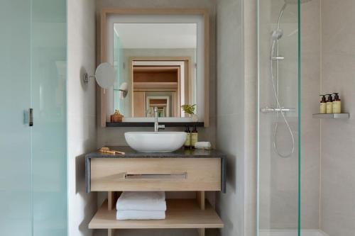 a bathroom with a sink and a mirror and a shower at ME Barcelona in Barcelona