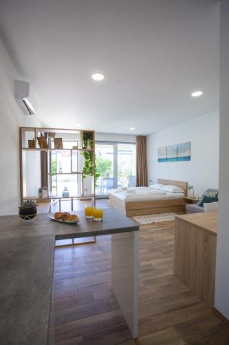 a living room with a bed and a bedroom at Poseidon Mobile Home Resort in Makarska