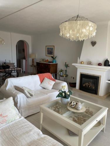 a living room with a couch and a coffee table at Superbe appartement vue sur mer à 180° Luz in Luz