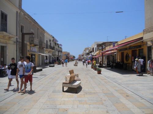 a group of people walking down a city street at RgB_Apartments in Lampedusa