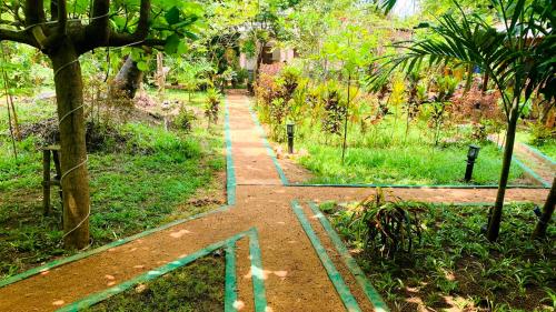 a walking path in a park with graffiti on it at Sigiri Starwing Villa in Sigiriya