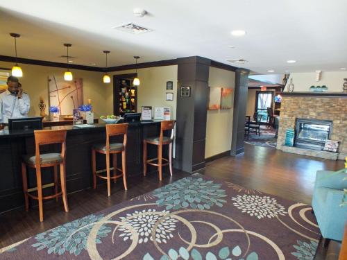 a man standing at a bar in a restaurant at Sonesta ES Suites Dallas - Las Colinas in Irving