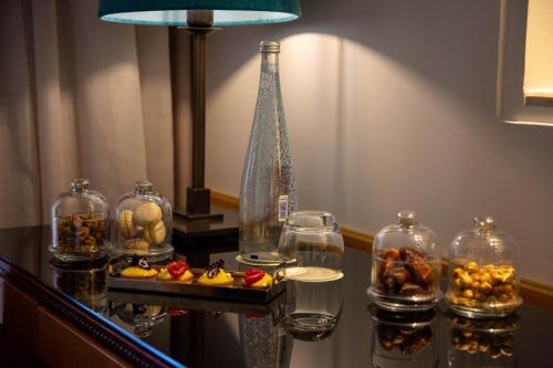 a table with several glass jars of food and a vase at Jaal Riad Resort in Marrakech
