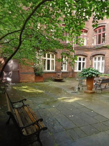 a park bench sitting in front of a building at Die Fabrik - Hostel in Berlin