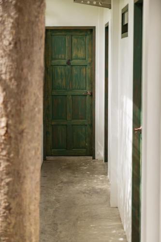 a hallway with a green door in a building at Big Tree Boutique Hotel in Ko Tao