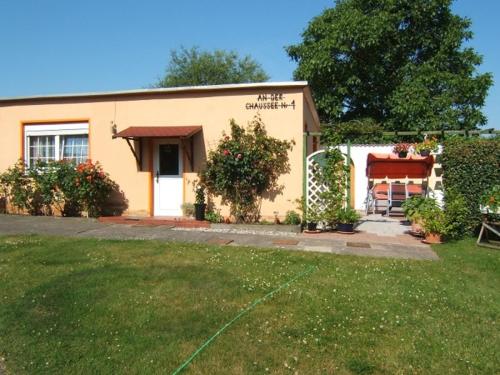 ein kleines Haus mit einem Hof davor in der Unterkunft Ferienwohnung Sehlen auf Rügen in Sehlen
