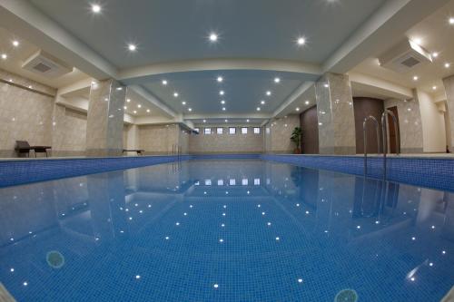 a large swimming pool in a building at Hotel Astoria Tbilisi in Tbilisi City