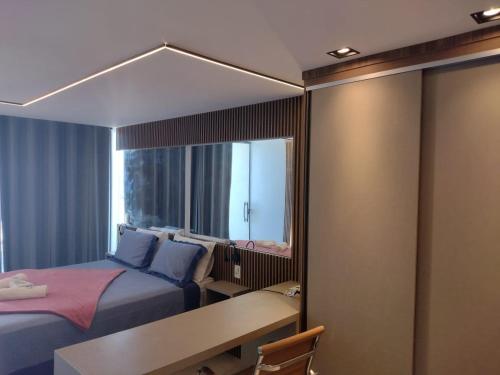 a room with two beds and a desk and a mirror at Deck de Búzios in Búzios