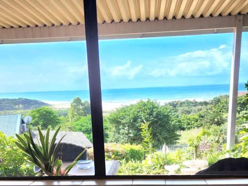 a window view of the ocean from a house at Seaview Villa 25 in Shelly Beach