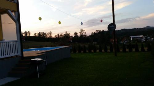 a group of kites flying in the sky over a yard at Villa Ducic in Zlatibor